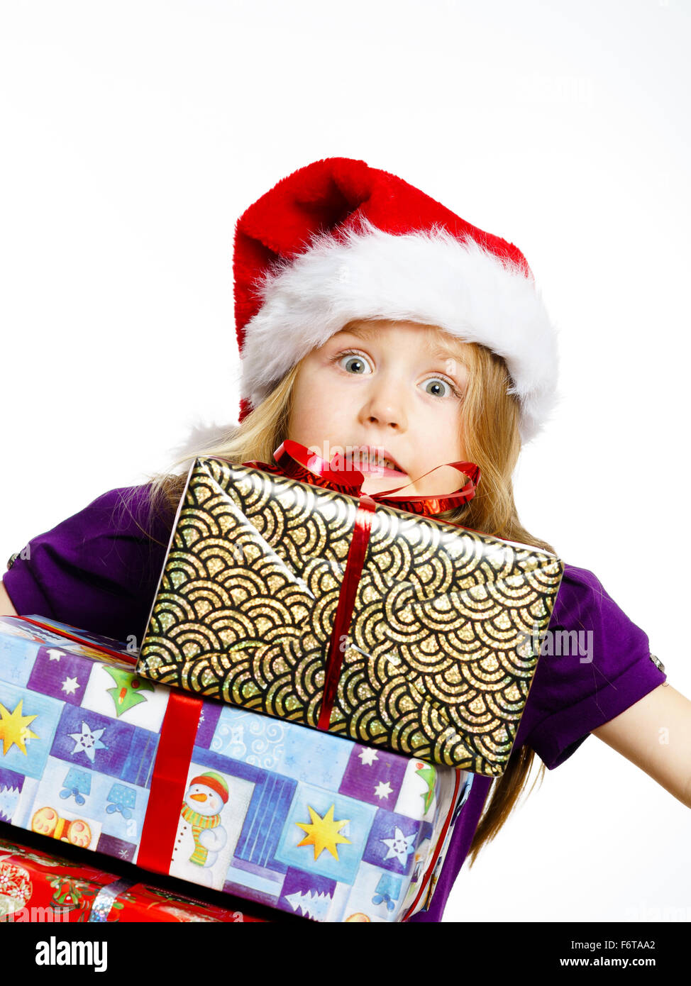 Cute little preschooler girl in red santa hat with gift box isolated on ...