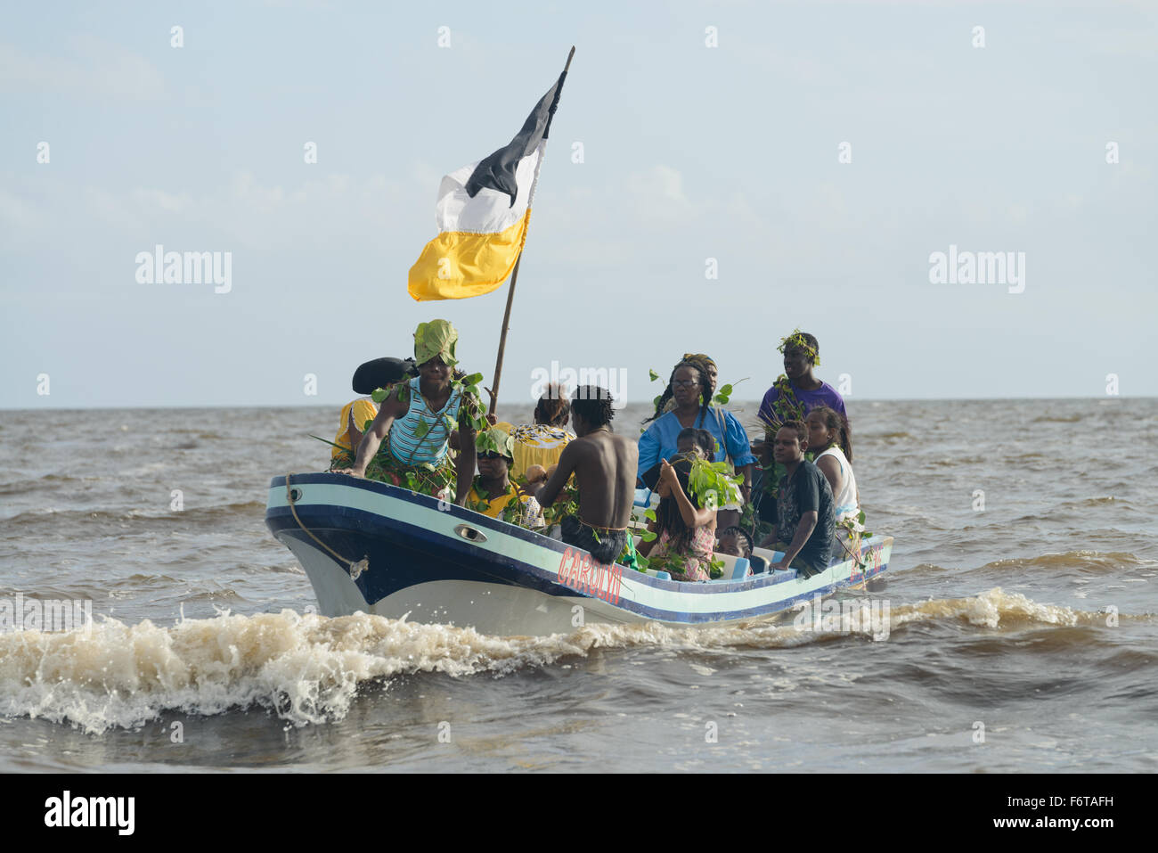 Hopkins Village, Belize, - November 19, 2015: The Garifuna people of Belize celebrate the landing of the first Garifuna people on the shores of Belize from Africa. This is a very important annual celebration for the Garifuna people and a time when they proudly show of their history and cultural heritage. Here they re-enact the first boat from Africa approaching the shores of Belize. Credit:  Roi Brooks/Alamy Live News Stock Photo