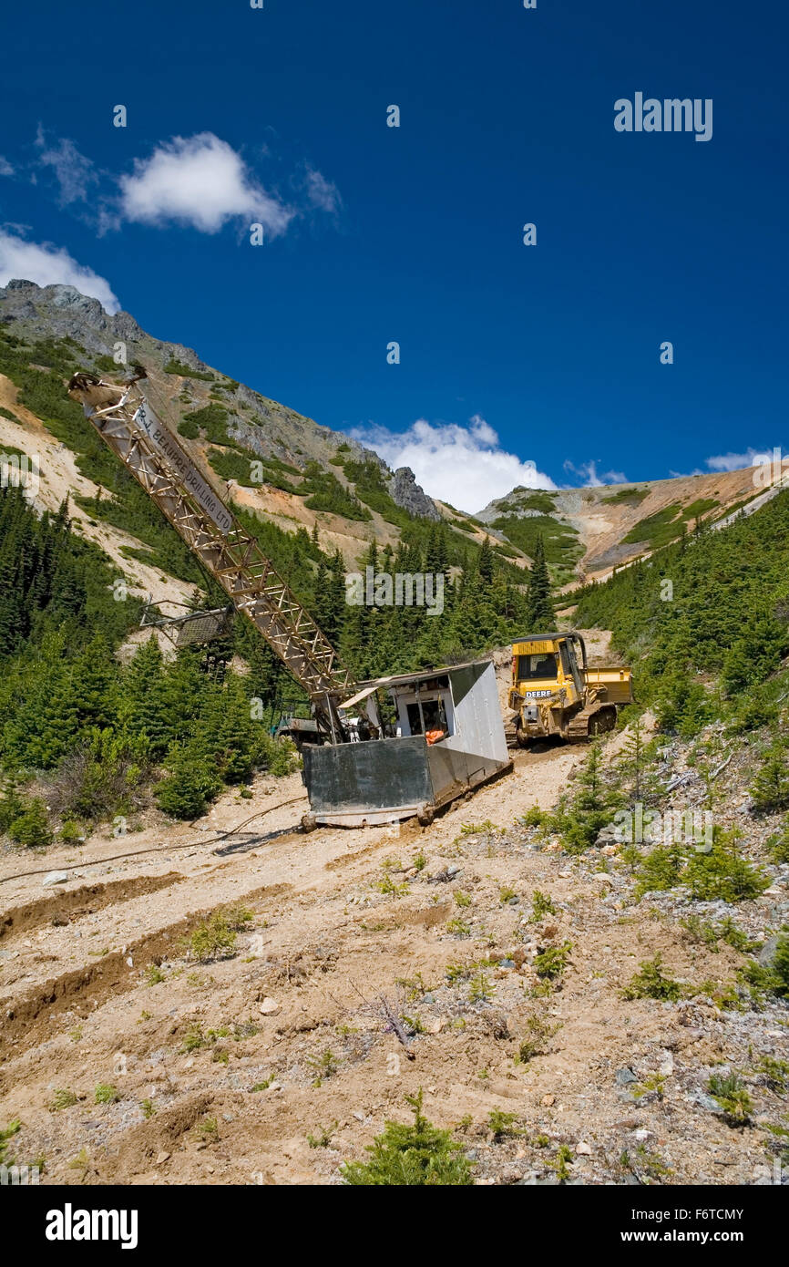 Bulldozer moving diamond drilling rig, Astlais mountain, BC Stock Photo