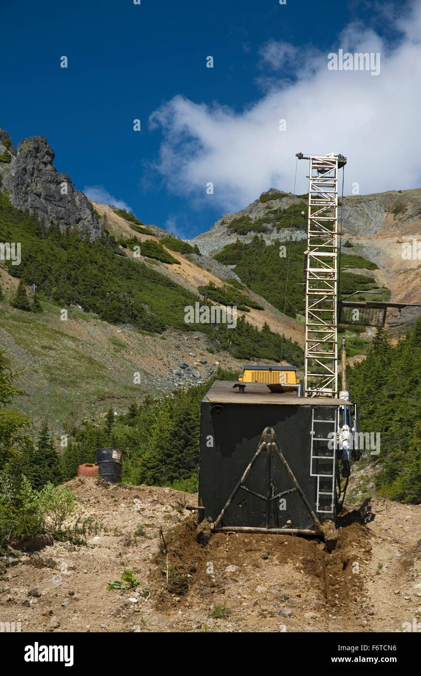 Bulldozer moving diamond drilling rig, Astlais mountain, BC Stock Photo