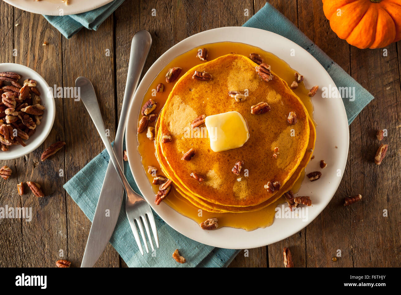 Homemade Pumpkin Pancakes with Butter Pecans and Maple Syrup Stock Photo