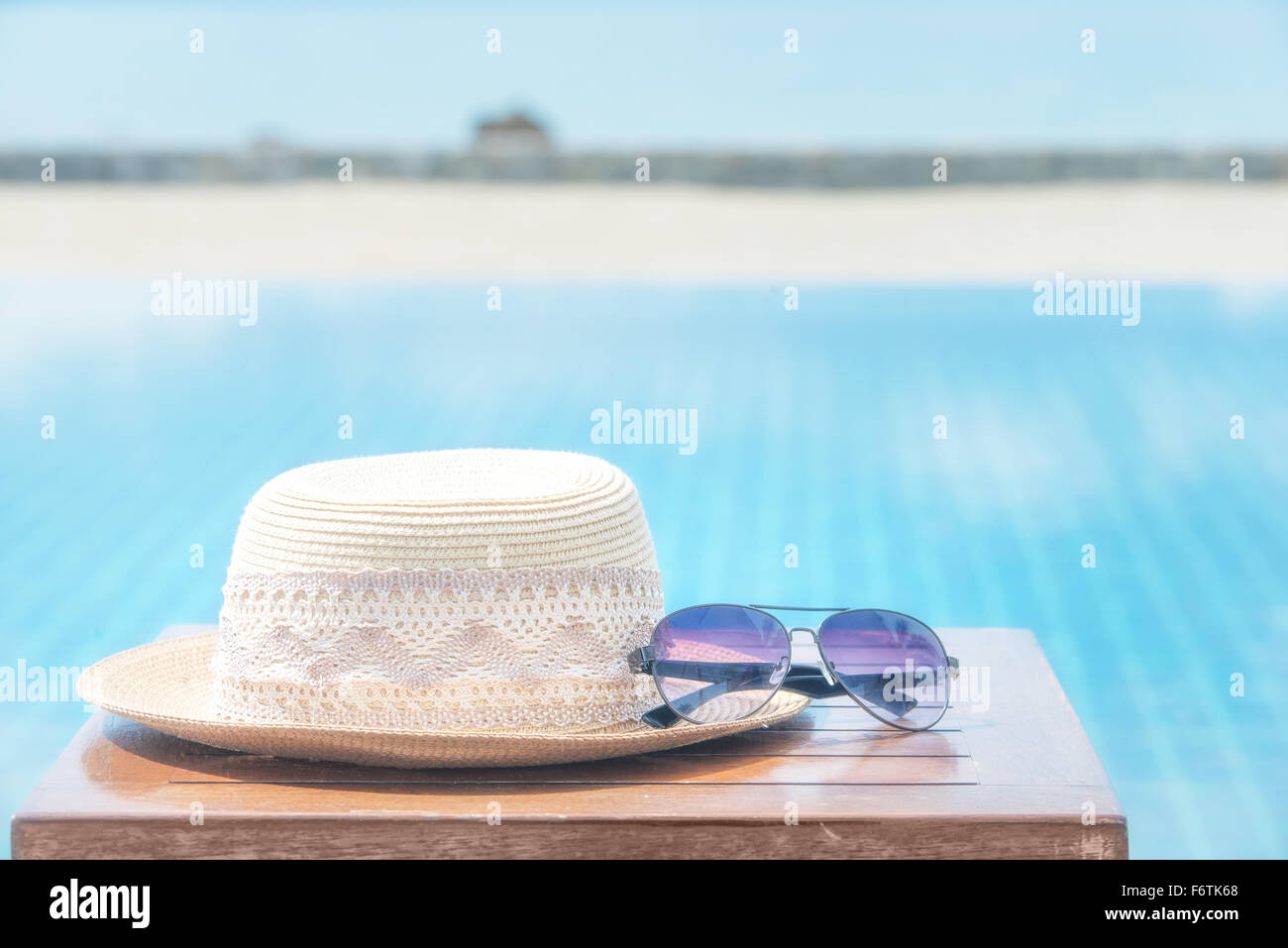 Hat and sunglasses at the sea background Stock Photo