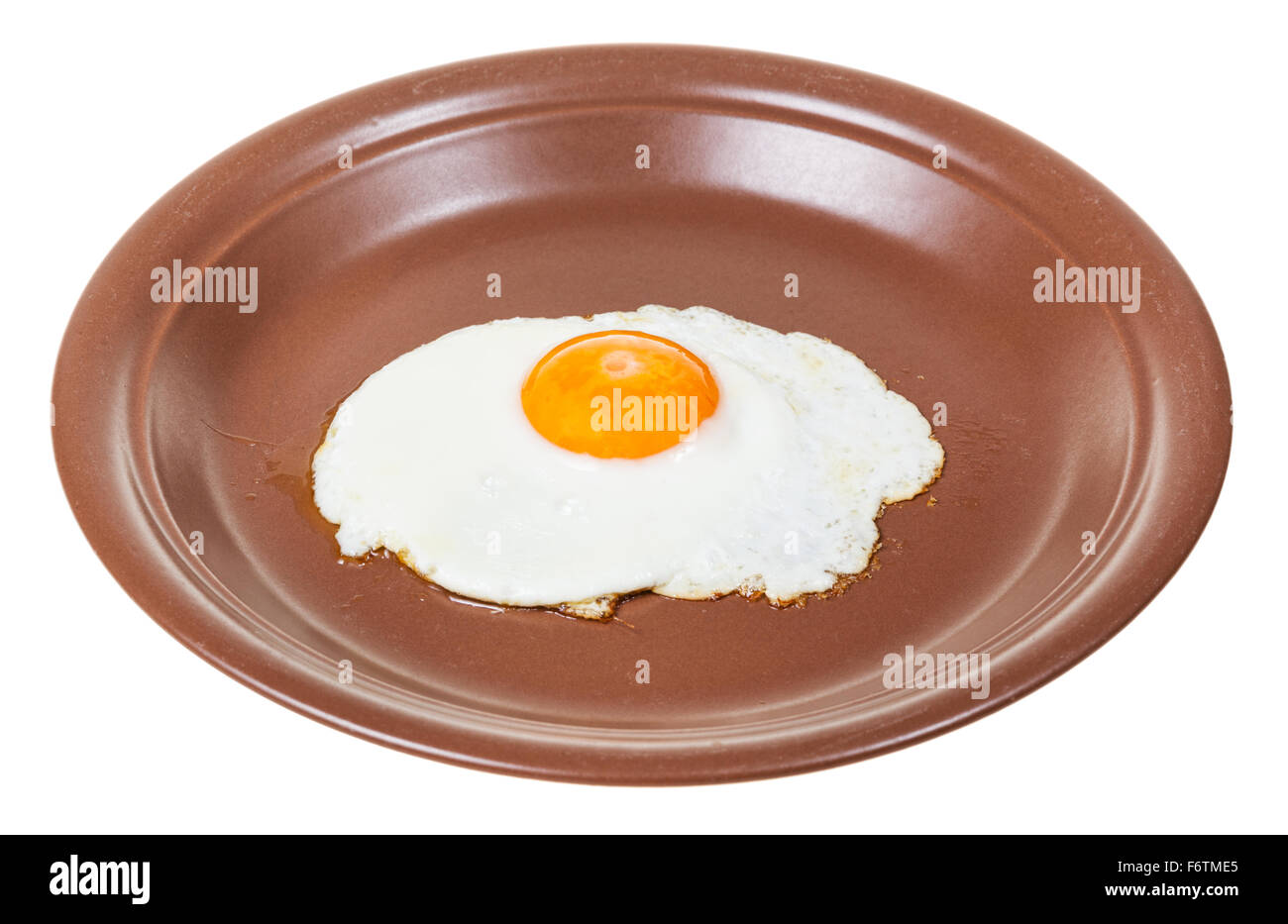 fried egg on brown plate isolated on white background Stock Photo - Alamy