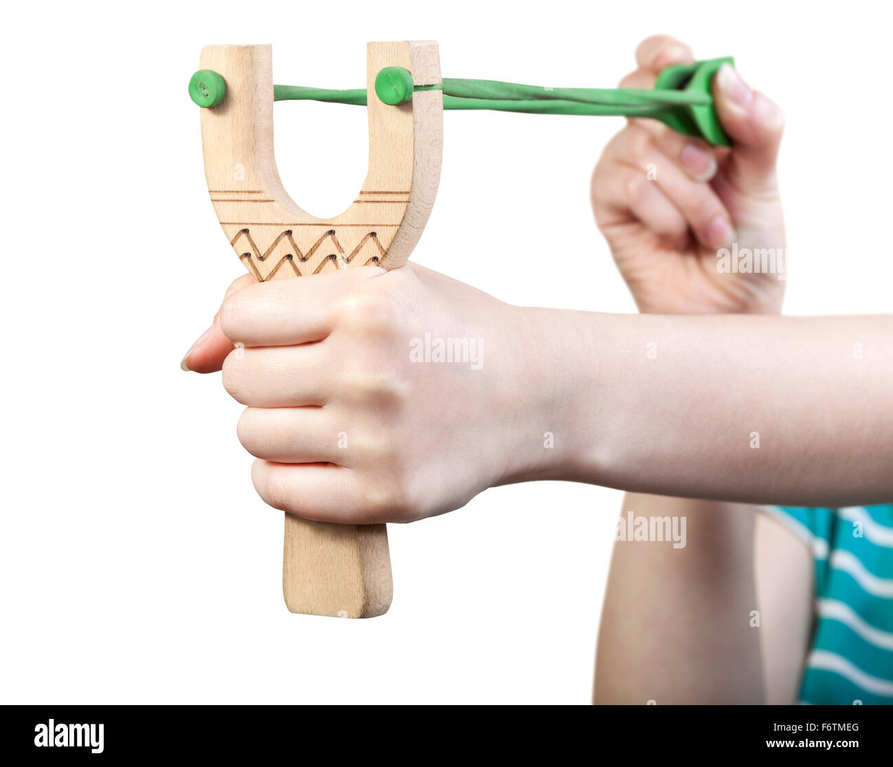 girl shoots from simple wooden slingshot isolated on white background Stock Photo