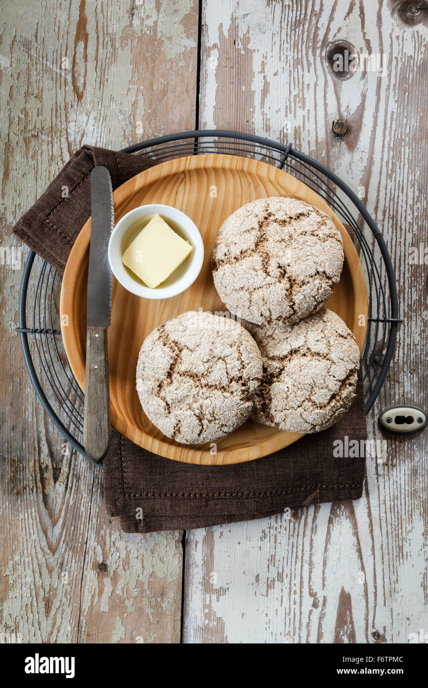 Rustic Rye Roll Homemade rye bread rolls on wooden plate and cooling grid Stock Photo ...