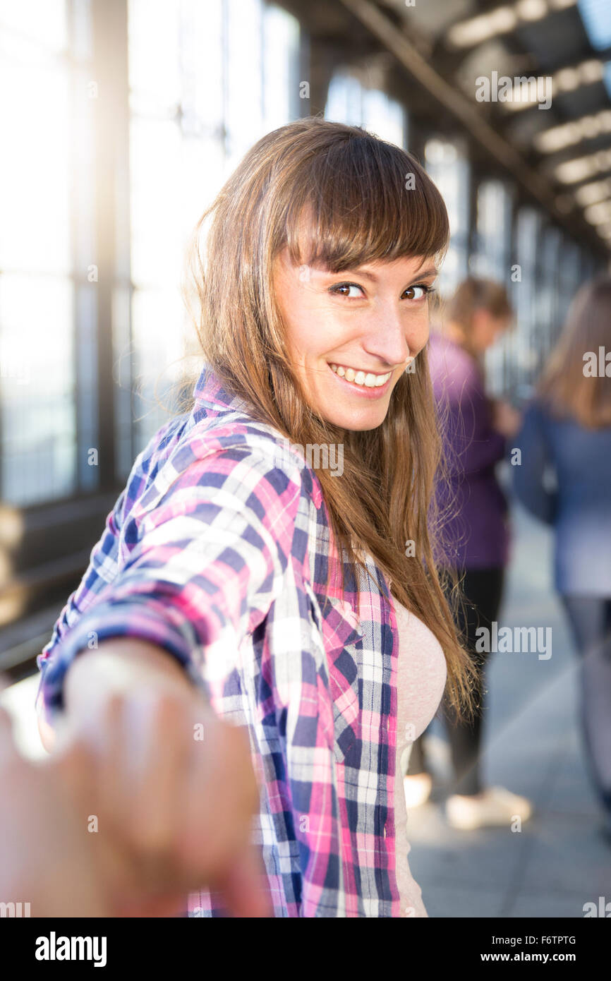 Portrait of smiling young woman holding hands Stock Photo - Alamy