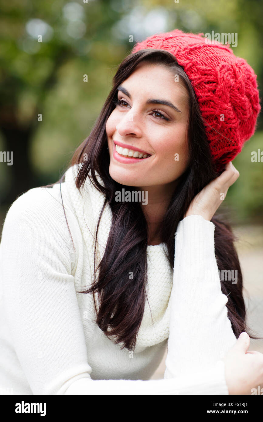 Portrait of smiling young woman wearing red woolly hat Stock Photo - Alamy