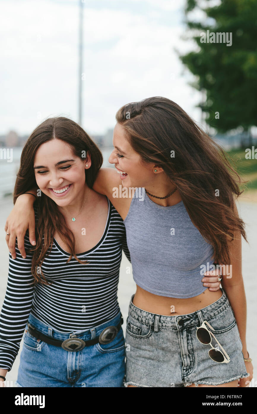 USA, New York City, two happy friends walking outdoors Stock Photo - Alamy