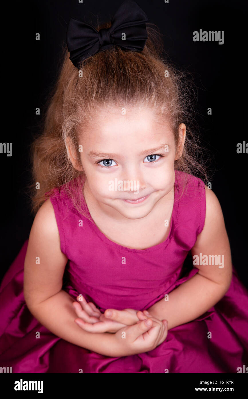 Portrait of a cute little girl in a pink dress in the studio Stock ...
