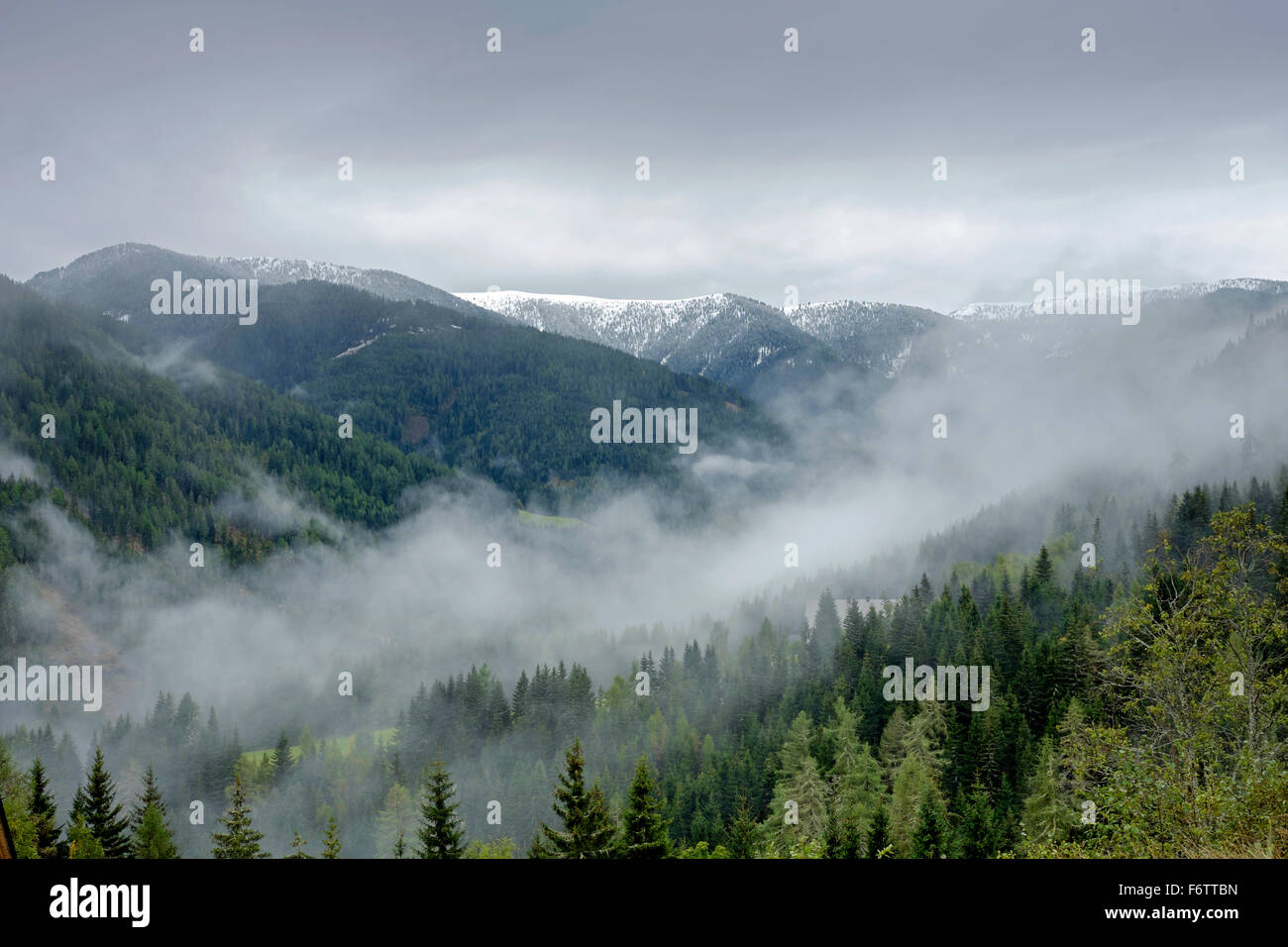 Austria, Styria, Murau, snow-capped mountains and fog in the valley Stock Photo