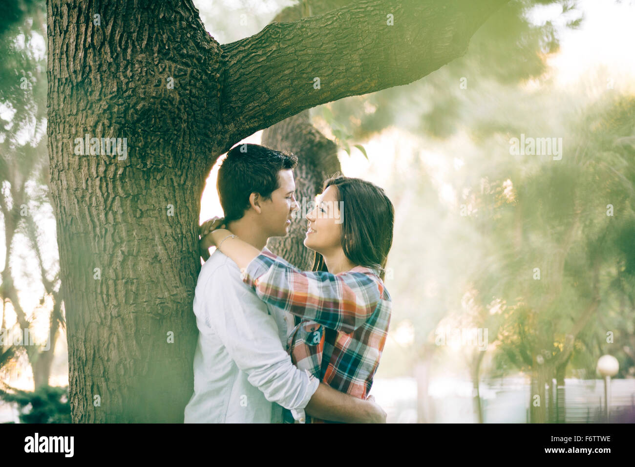 Young couple in love hugging in a park Stock Photo - Alamy