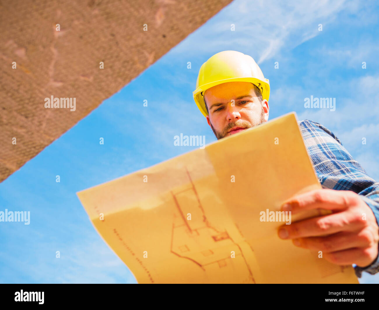 Foreman looking at construction plan Stock Photo