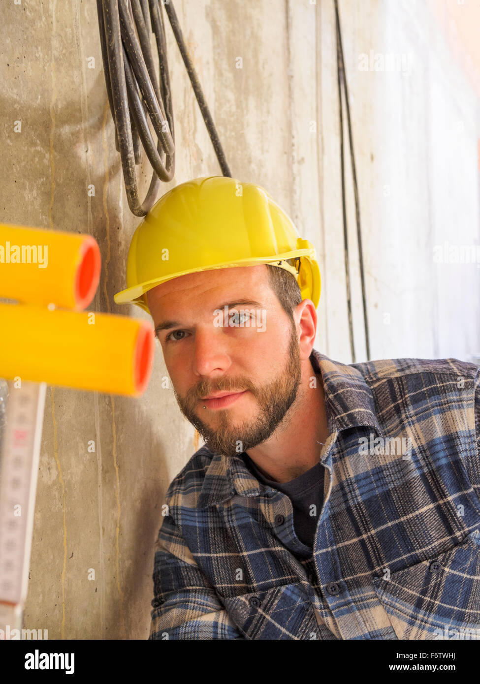 Foreman checking construction work with pocket rule Stock Photo - Alamy