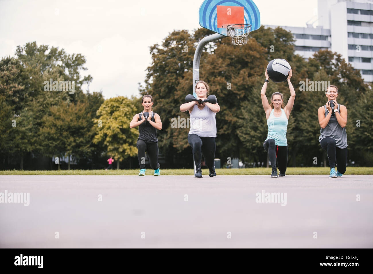 Four women having an outdoor boot camp workout Stock Photo