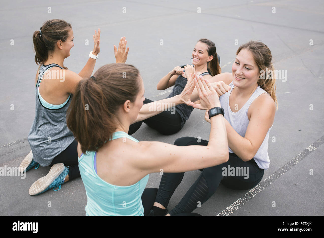 Four women having an outdoor boot camp workout Stock Photo