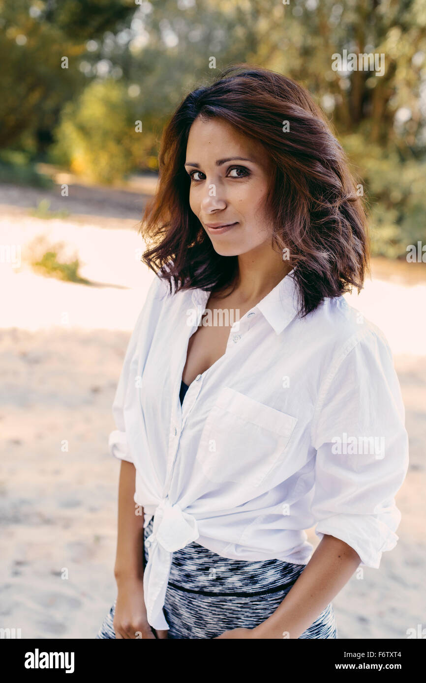 Portrait of smiling woman with brown hair Stock Photo - Alamy