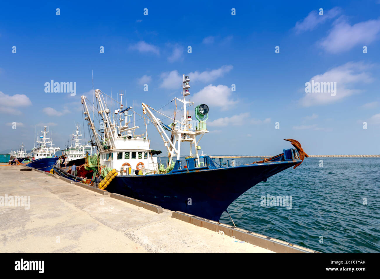 fishing boats docked at harbor Stock Photo