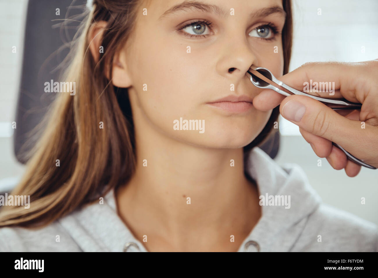 ENT doctor examining teenage girl with nasal speculum Stock Photo Alamy