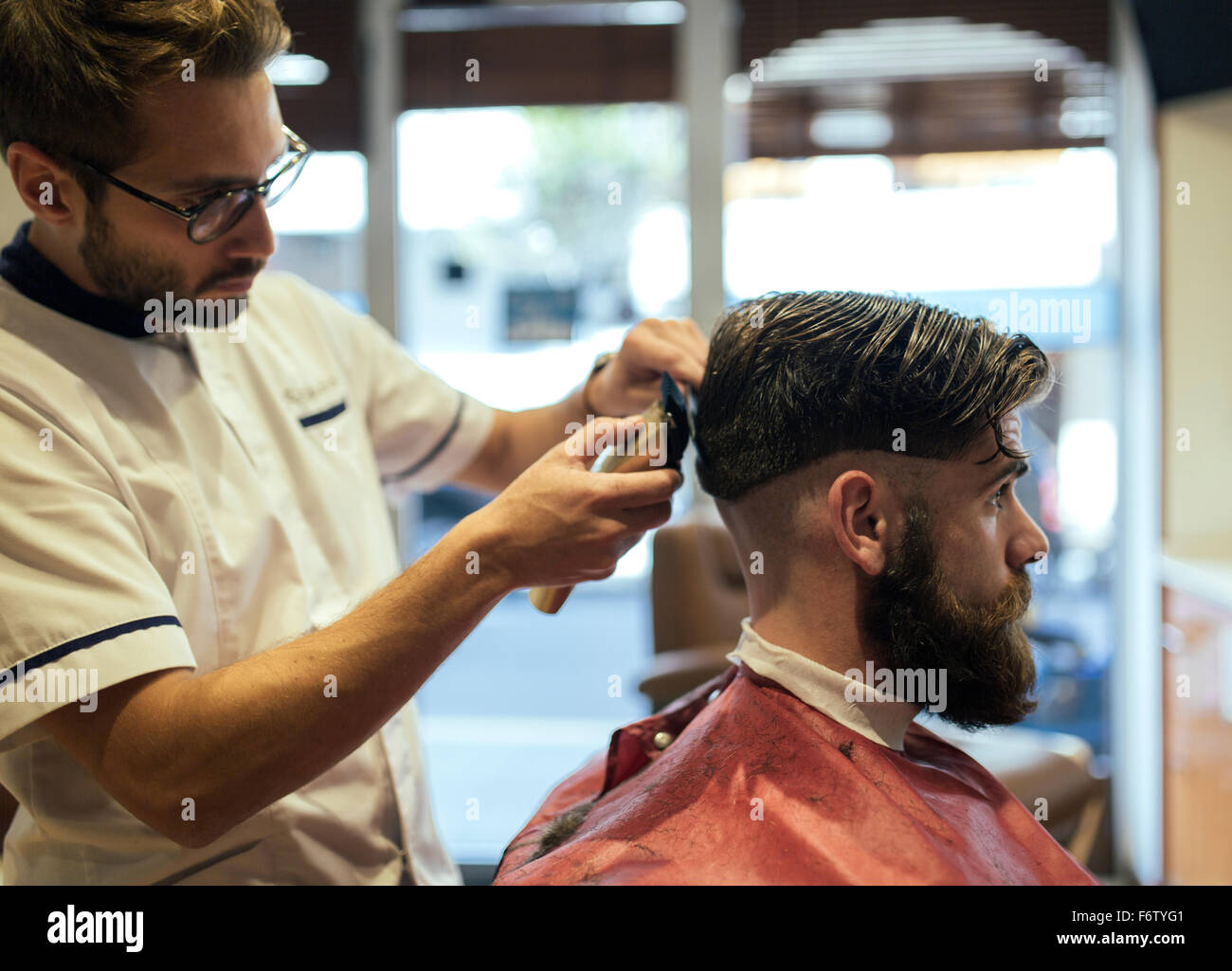 Barber shaving head of a customer Stock Photo Alamy