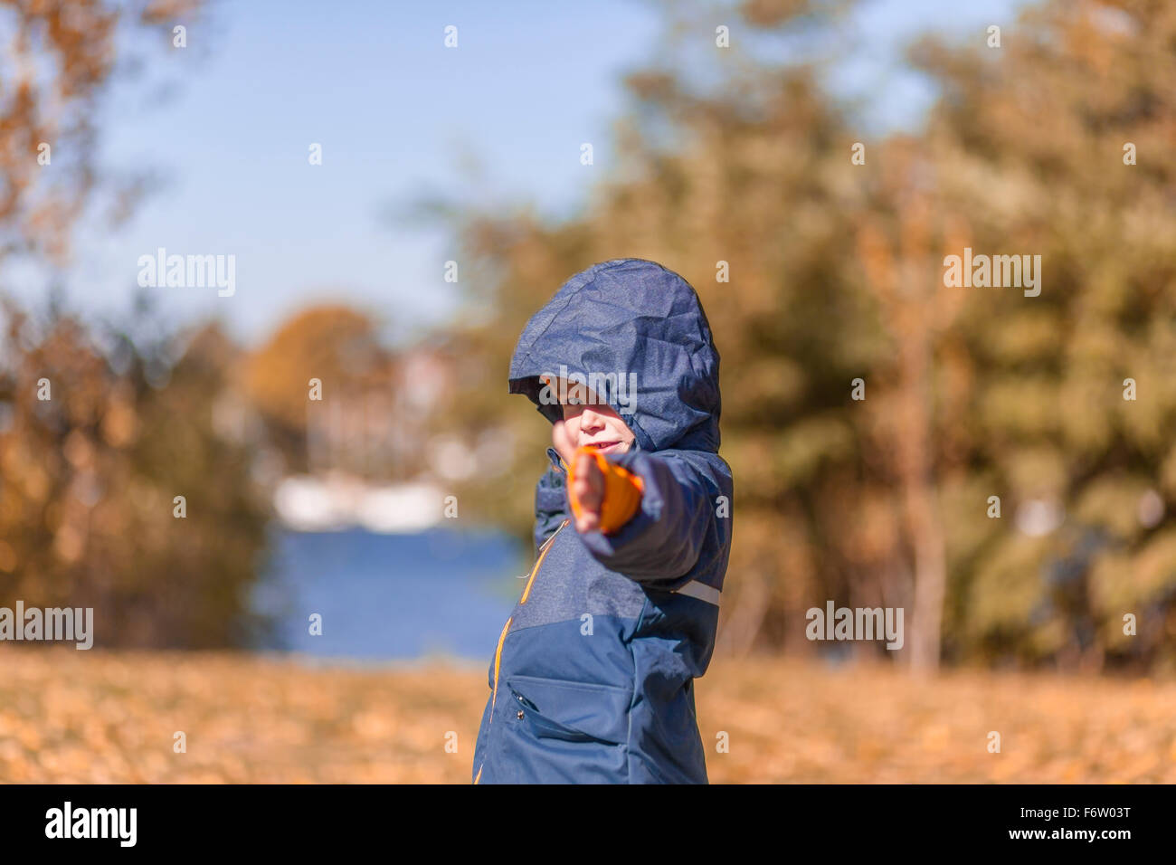 Little boy with rain jacket in the nature Stock Photo