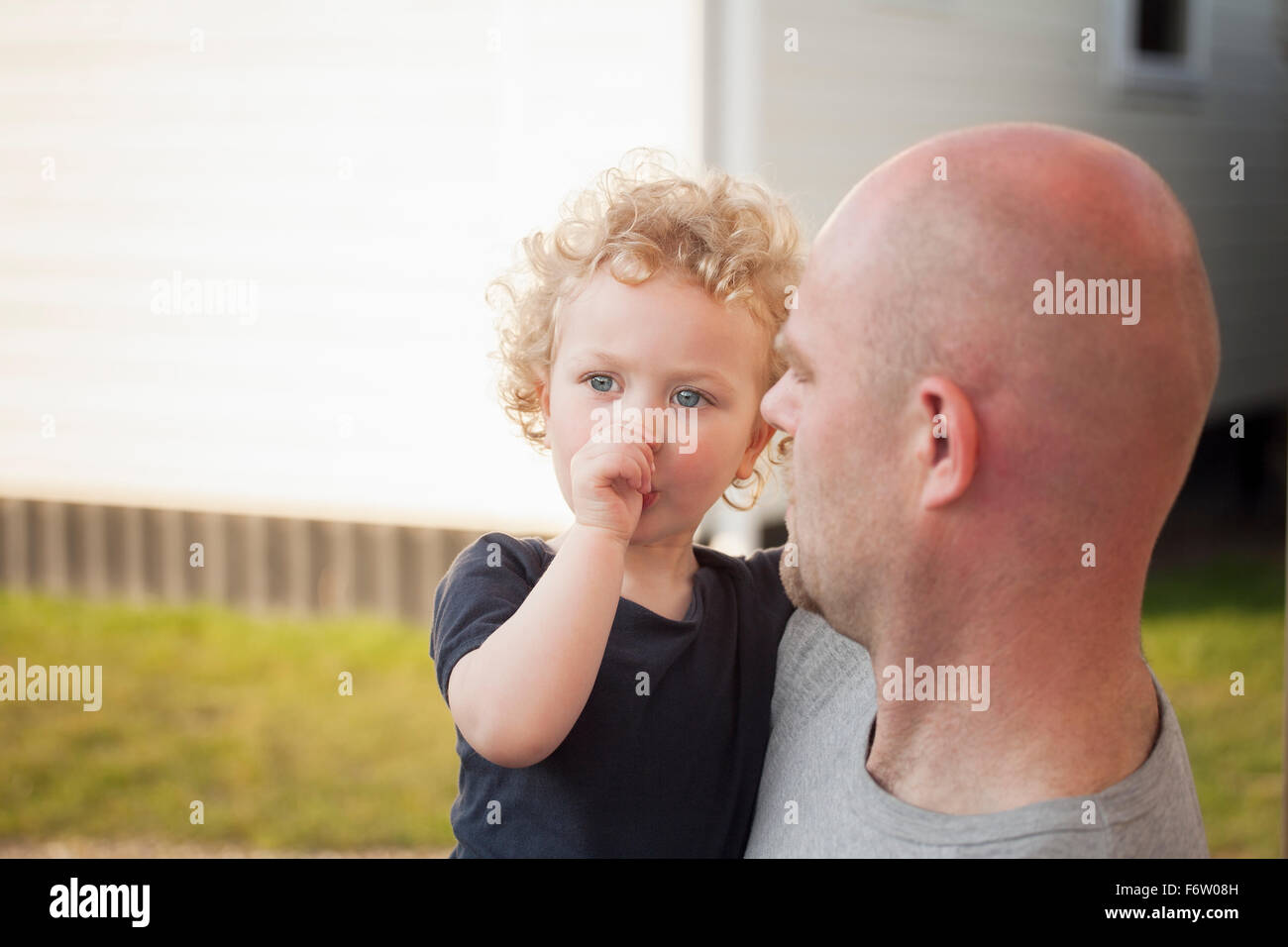 Father carrying little daughter outdoors Stock Photo