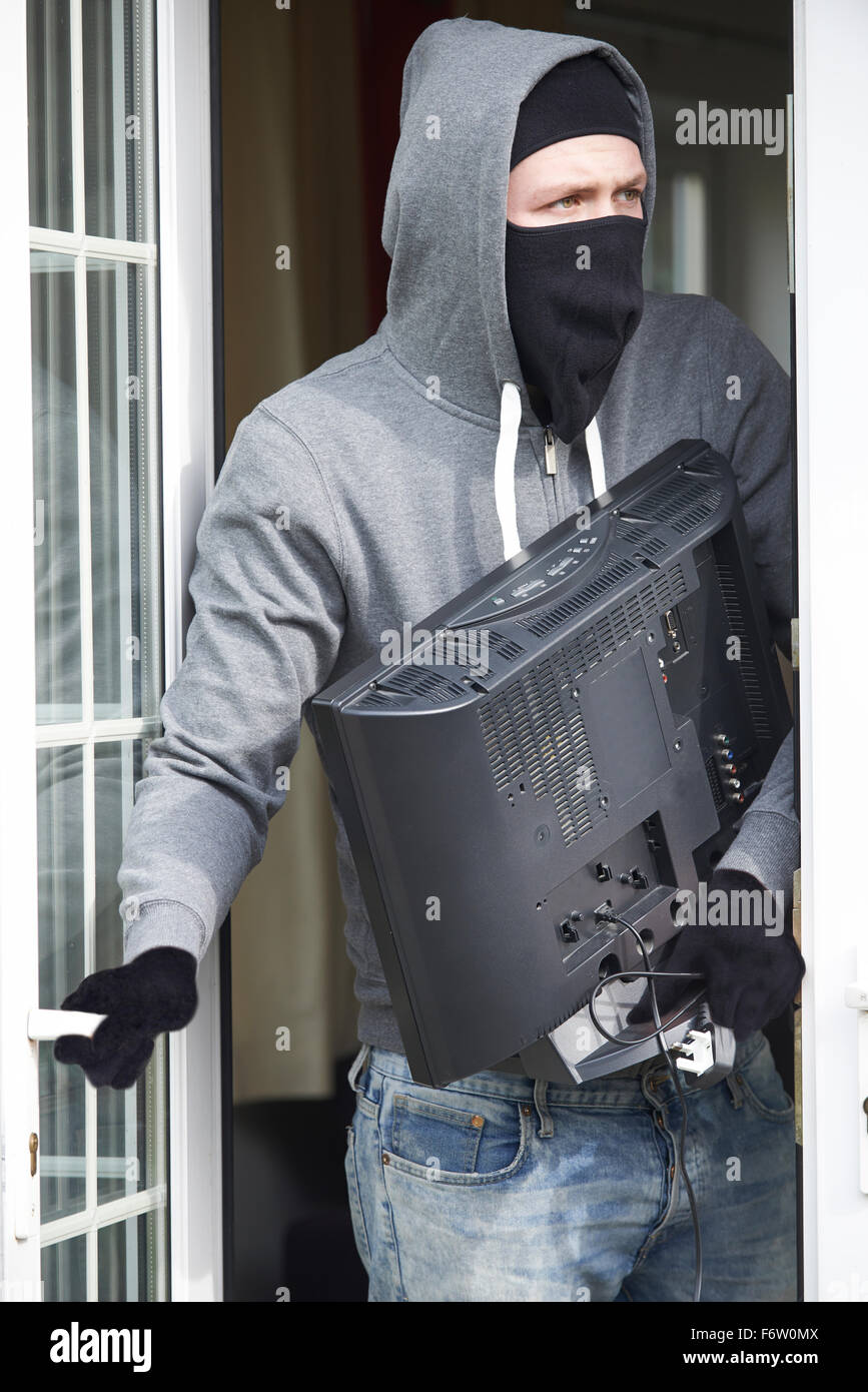 Burglar Breaking Into House And Stealing Television Stock Photo Alamy