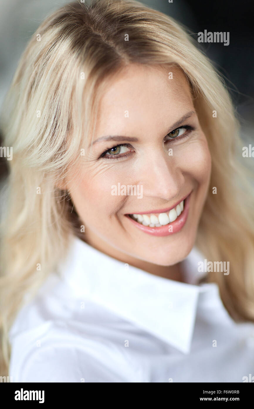 Portrait of smiling blond woman Stock Photo - Alamy