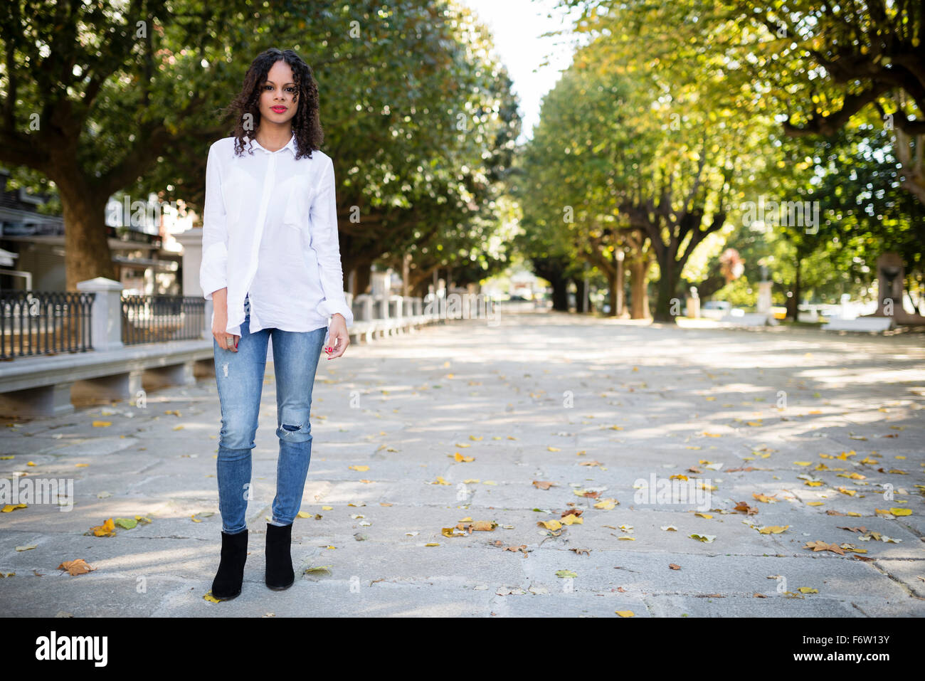 Portrait of young woman in a park Stock Photo - Alamy