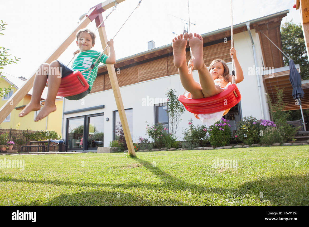 Brother sister on swing together hi-res stock photography and images ...