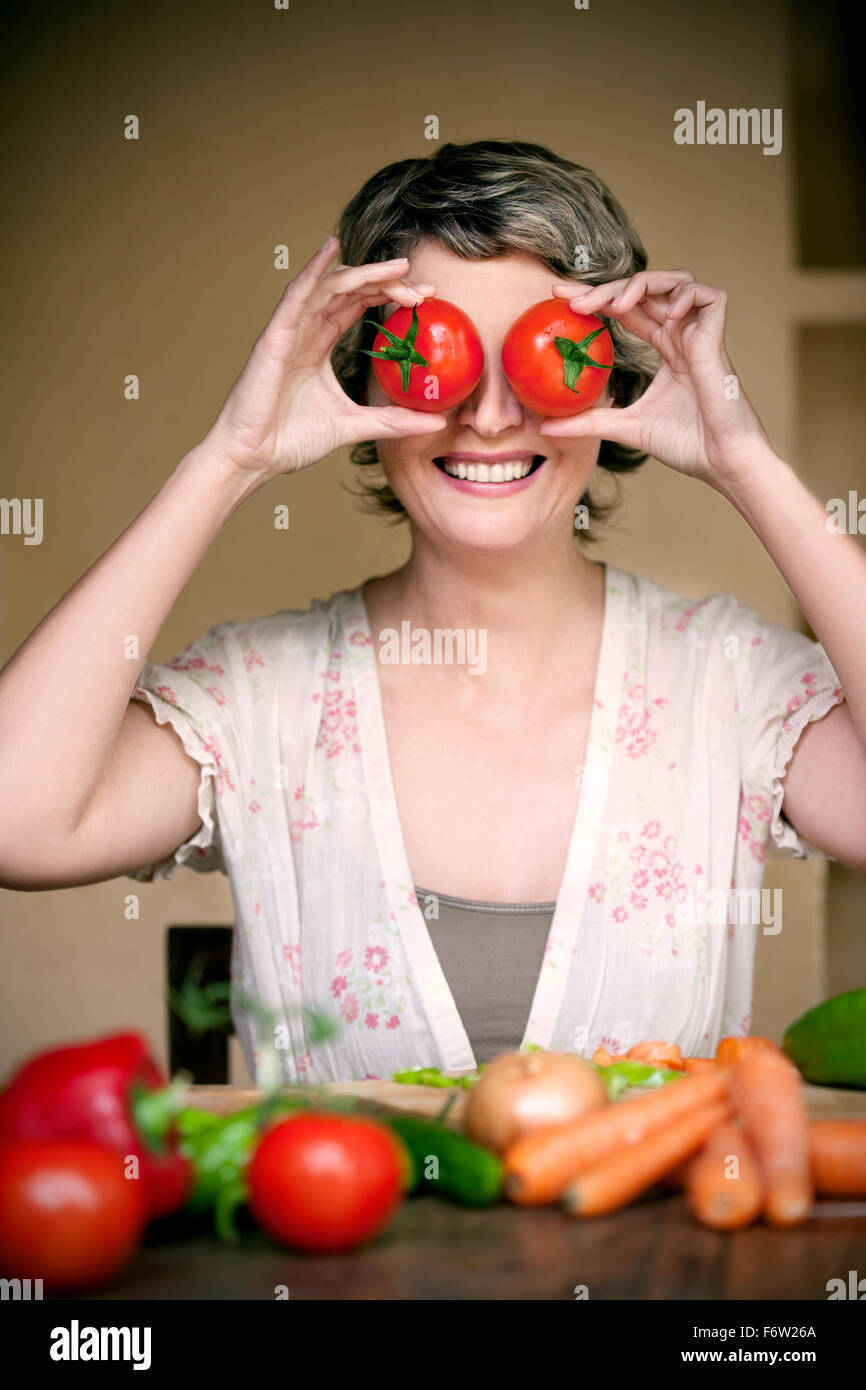Portrait of smiling woman with tomatoes on her eyes Stock Photo - Alamy