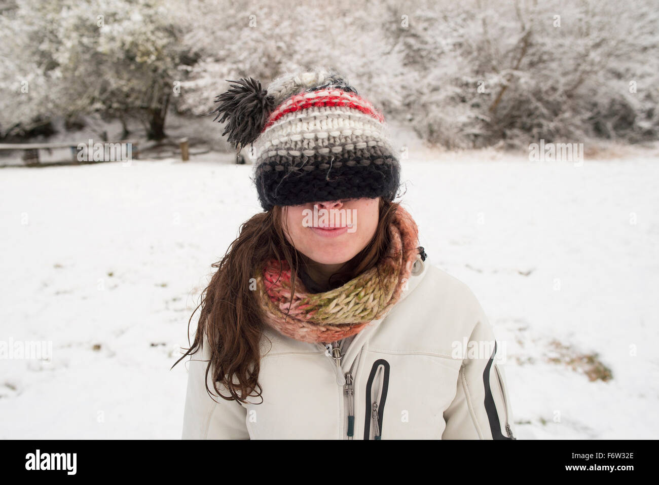 Young woman in winter wearing wooly hat covering her eyes Stock Photo ...