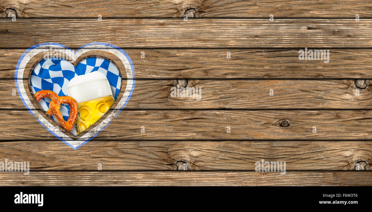 wooden board with heart-shaped cut out beer mug pretzel and bavarian flag Stock Photo