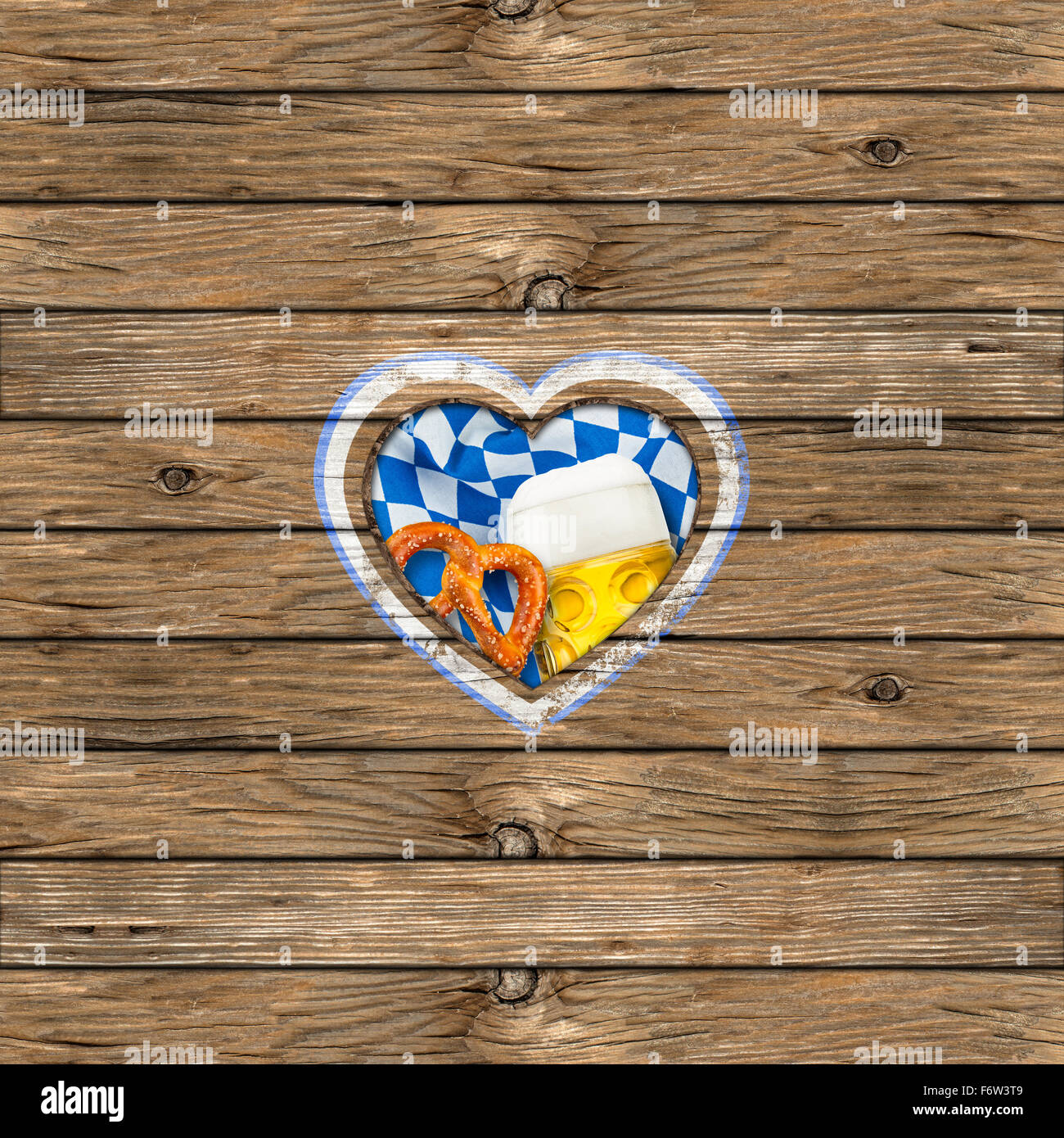 wooden board with heart-shaped cut out beer mug pretzel and bavarian flag Stock Photo