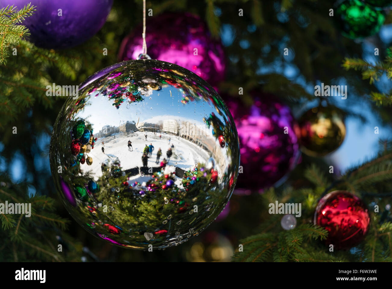 Colourful Christmas ball ornaments on a giant Christmas tree on
