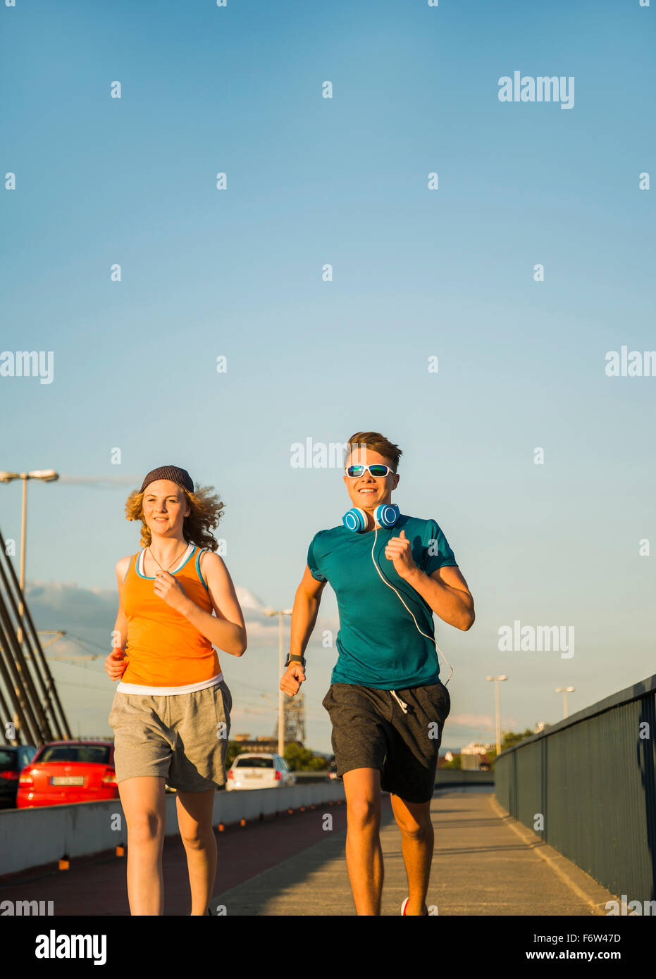 Young couple running on a bridge Stock Photo