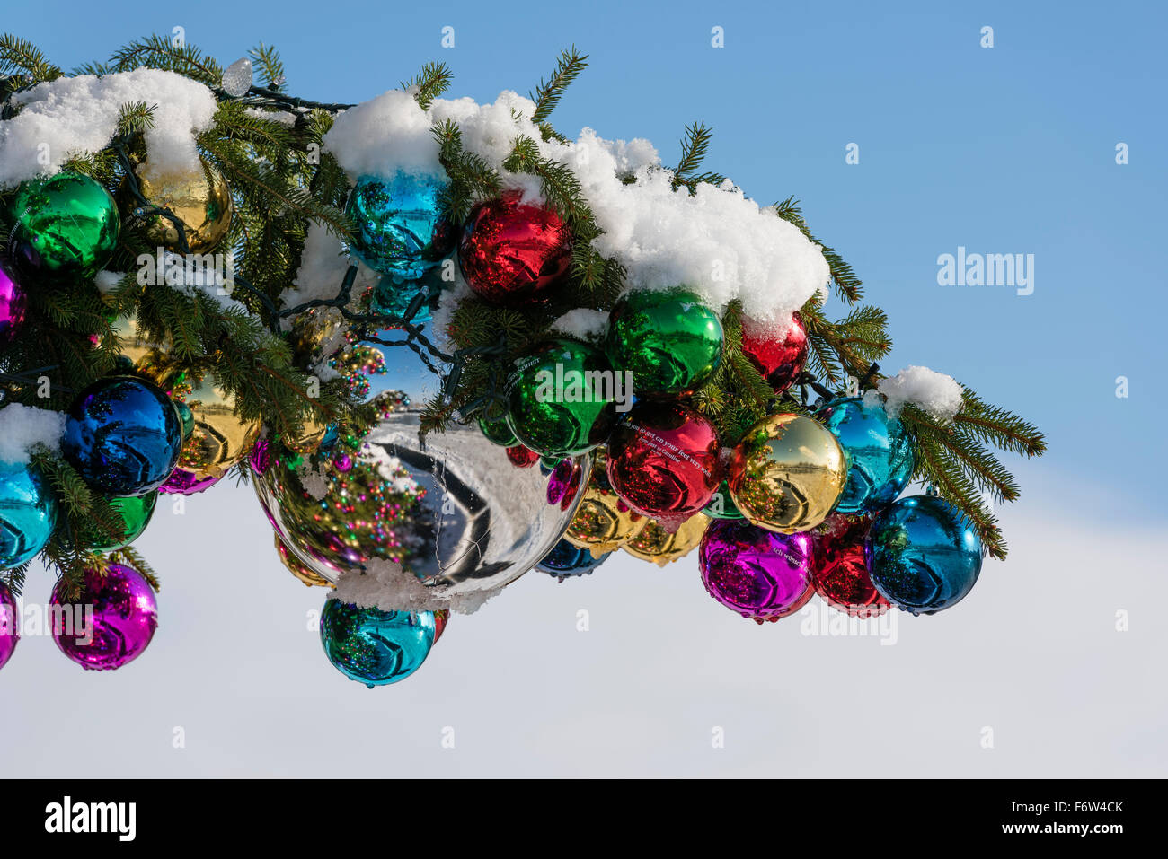 Colourful Christmas ball ornaments on a giant Christmas tree on