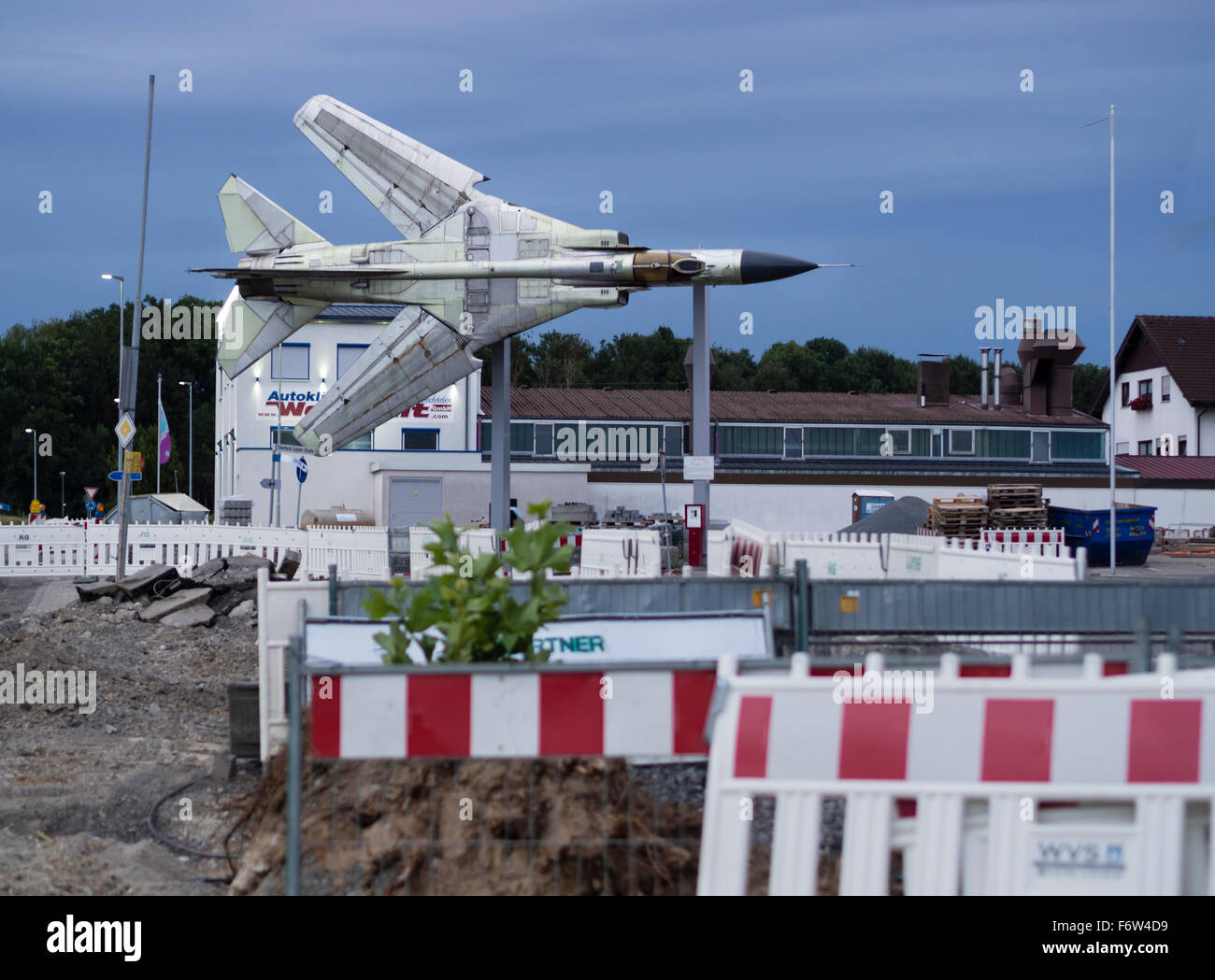 A discarded Russian MIG-23 fighter jet is set up for display in the midst of a temporary construction site in front of a museum. Stock Photo
