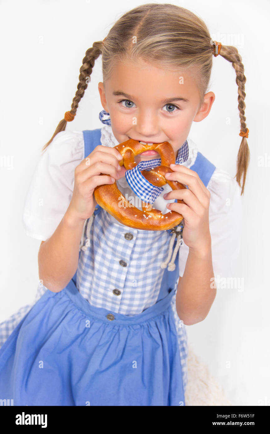 Portrait of little girl eating pretzel Stock Photo Alamy