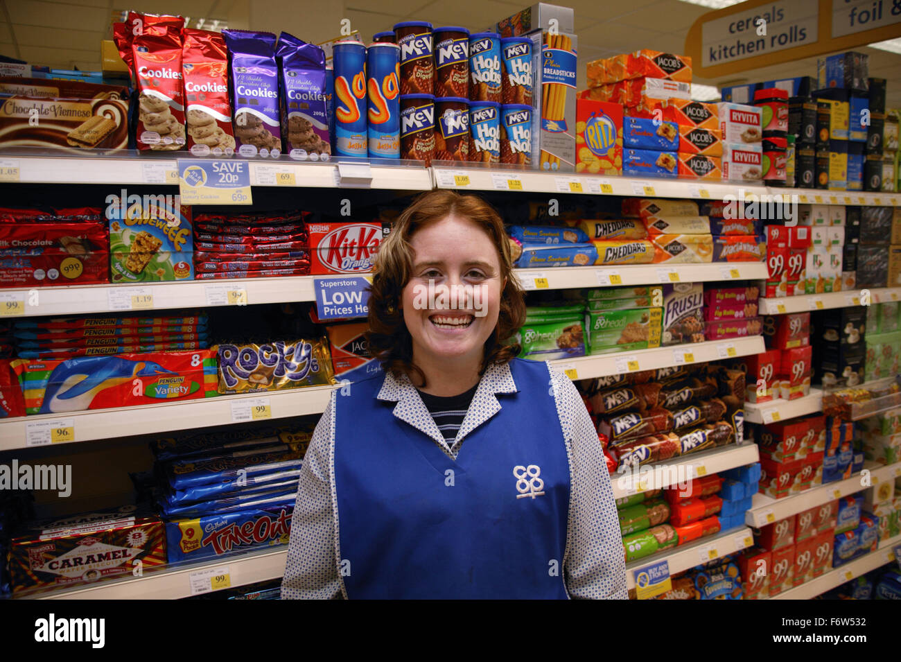 Portrait of shop assistant with learning disability standing in front ...