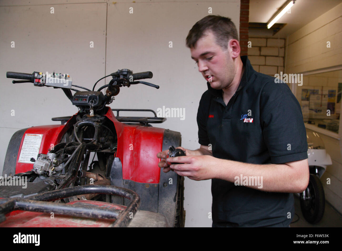 Man with Cerebral Palsy working as mechanic; repairing all terrain ...