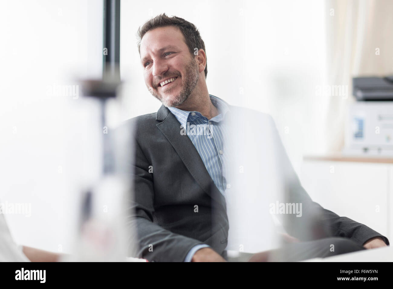 Smiling businessman in office Stock Photo - Alamy