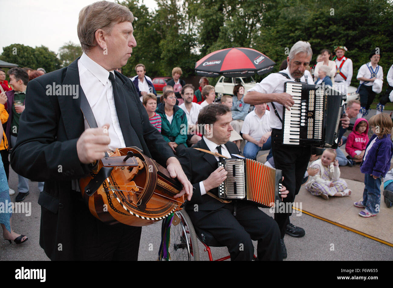 Group of musicians playing to Morris dancers performance