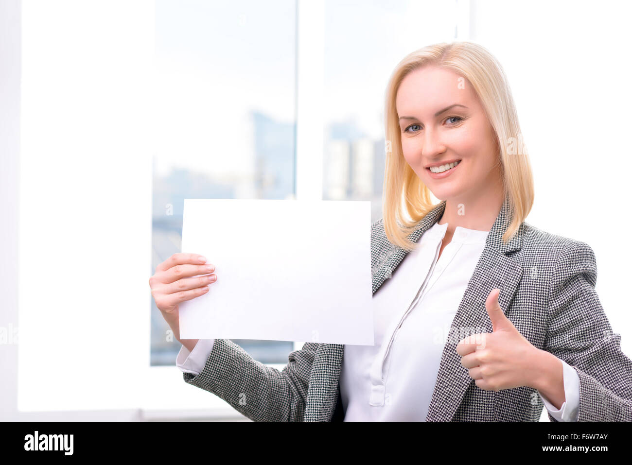Professional businesswoman holding sheet of paper Stock Photo - Alamy
