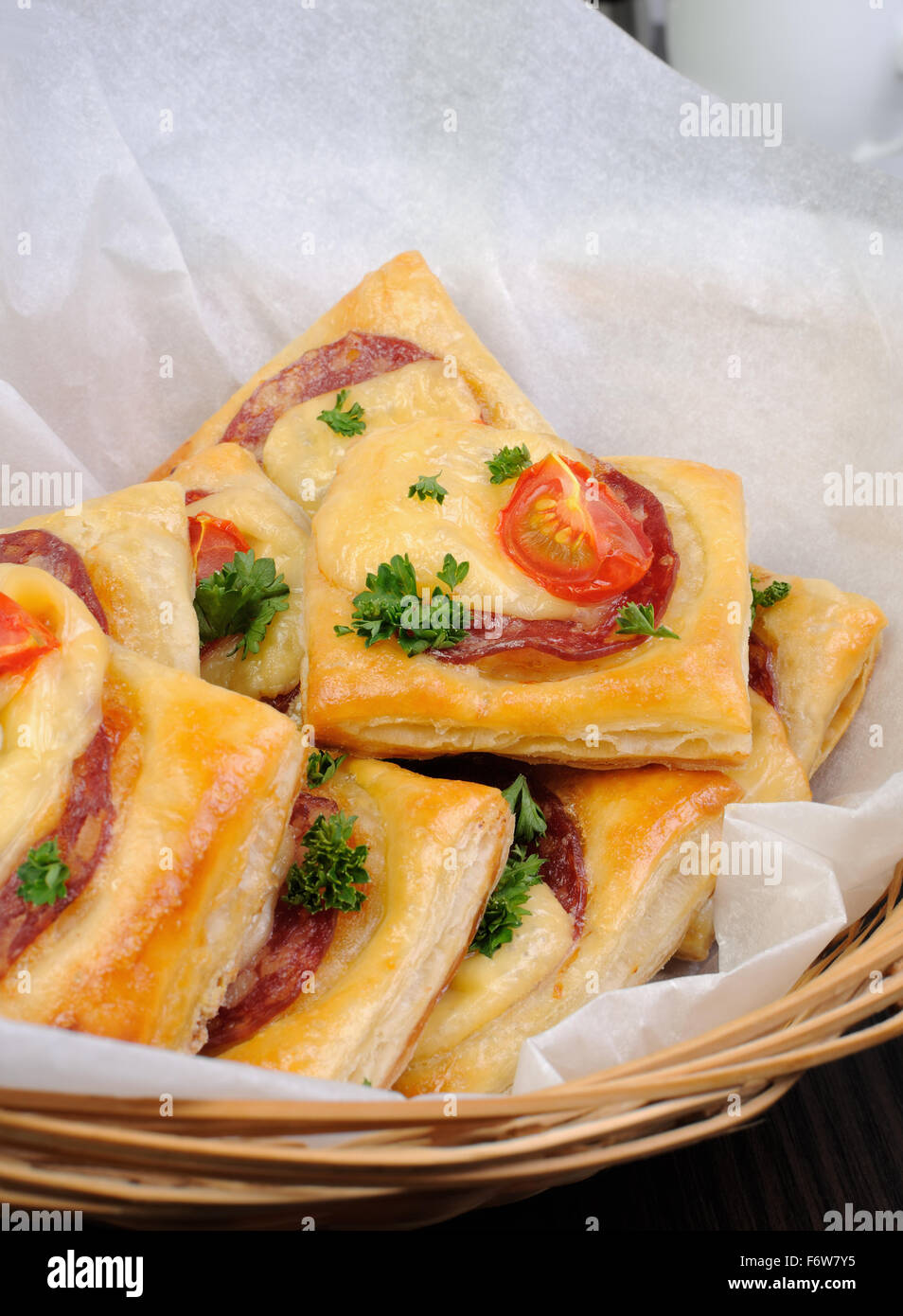 Appetizer of puff pastry with salami, cheese and cherry tomatoes Stock Photo