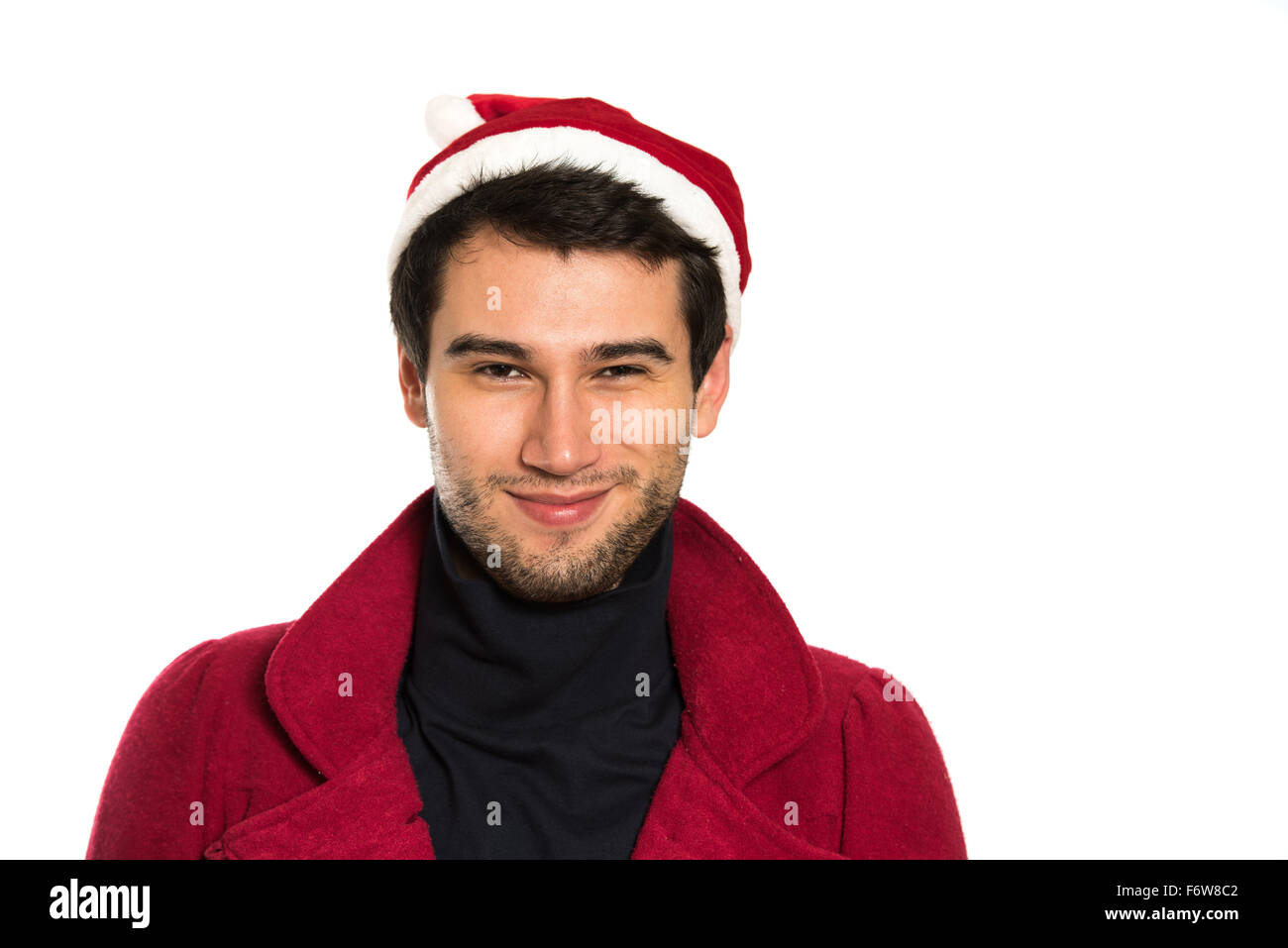 Young handsome brunette man wearing red hut, coat and black pullover, smiling, happy, on white background with copy space Stock Photo