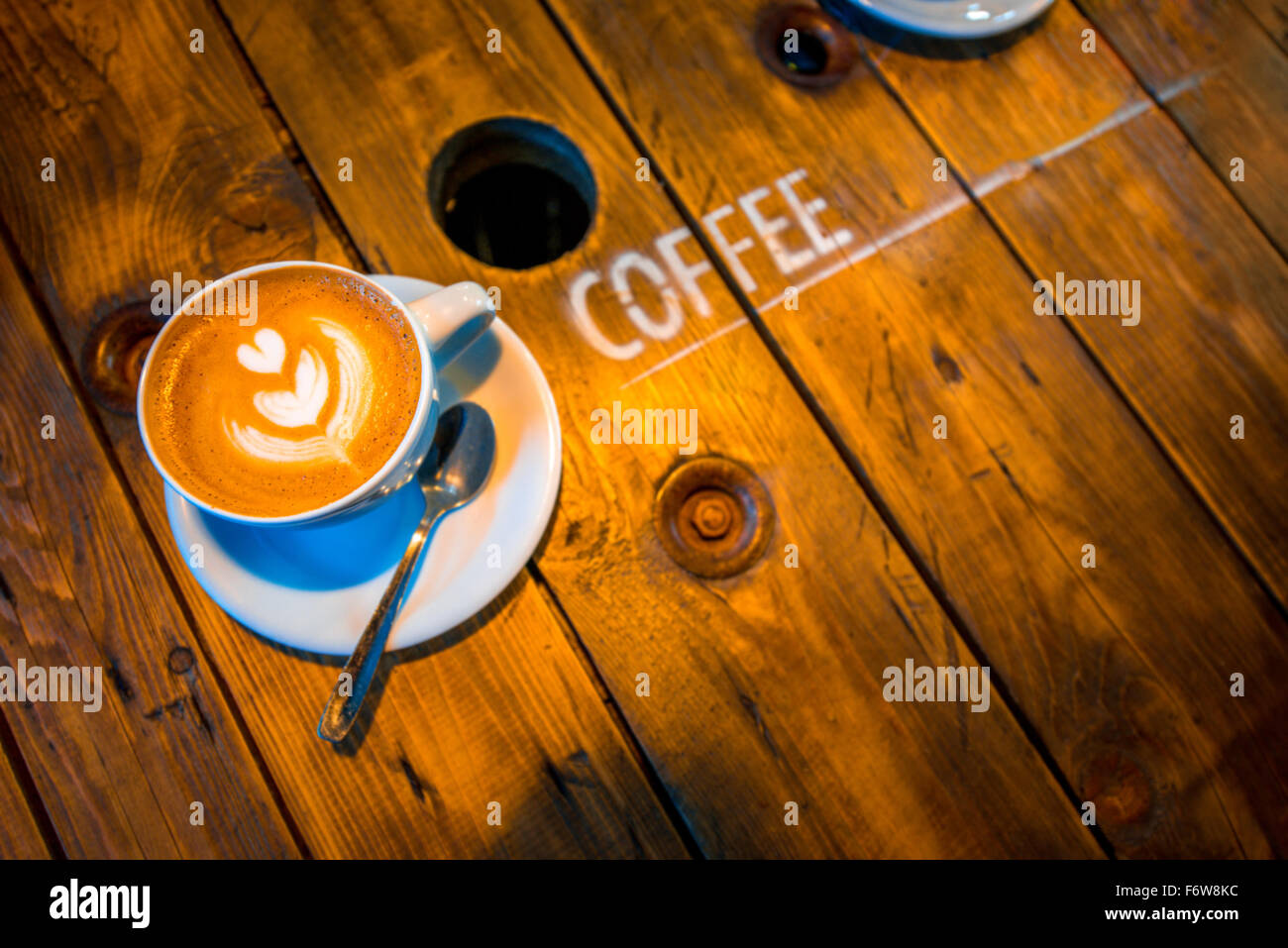Coffee cups with Cappuccino with beautiful art shape on the wooden table Stock Photo