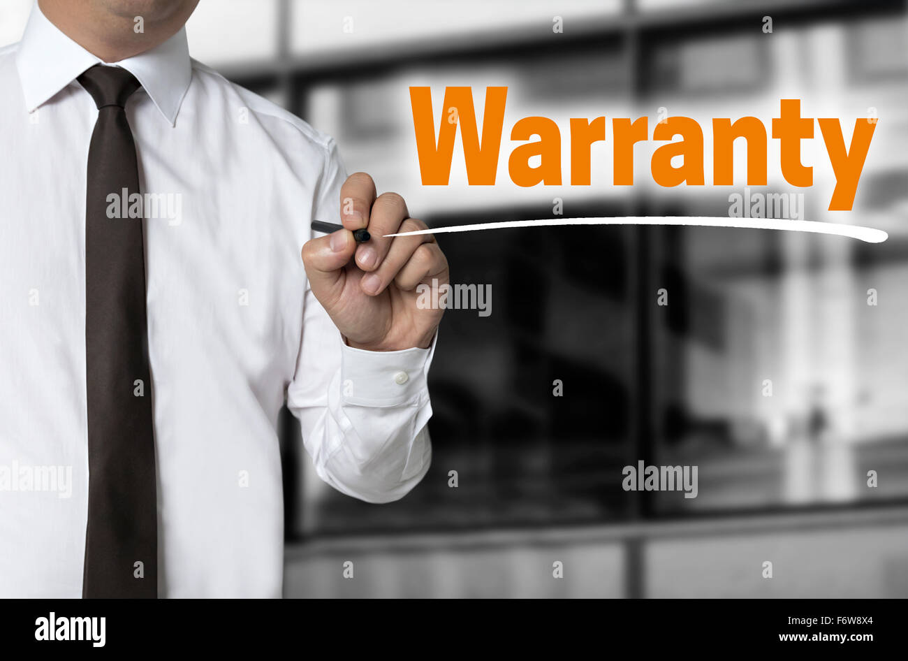 Warranty is written by businessman background concept. Stock Photo