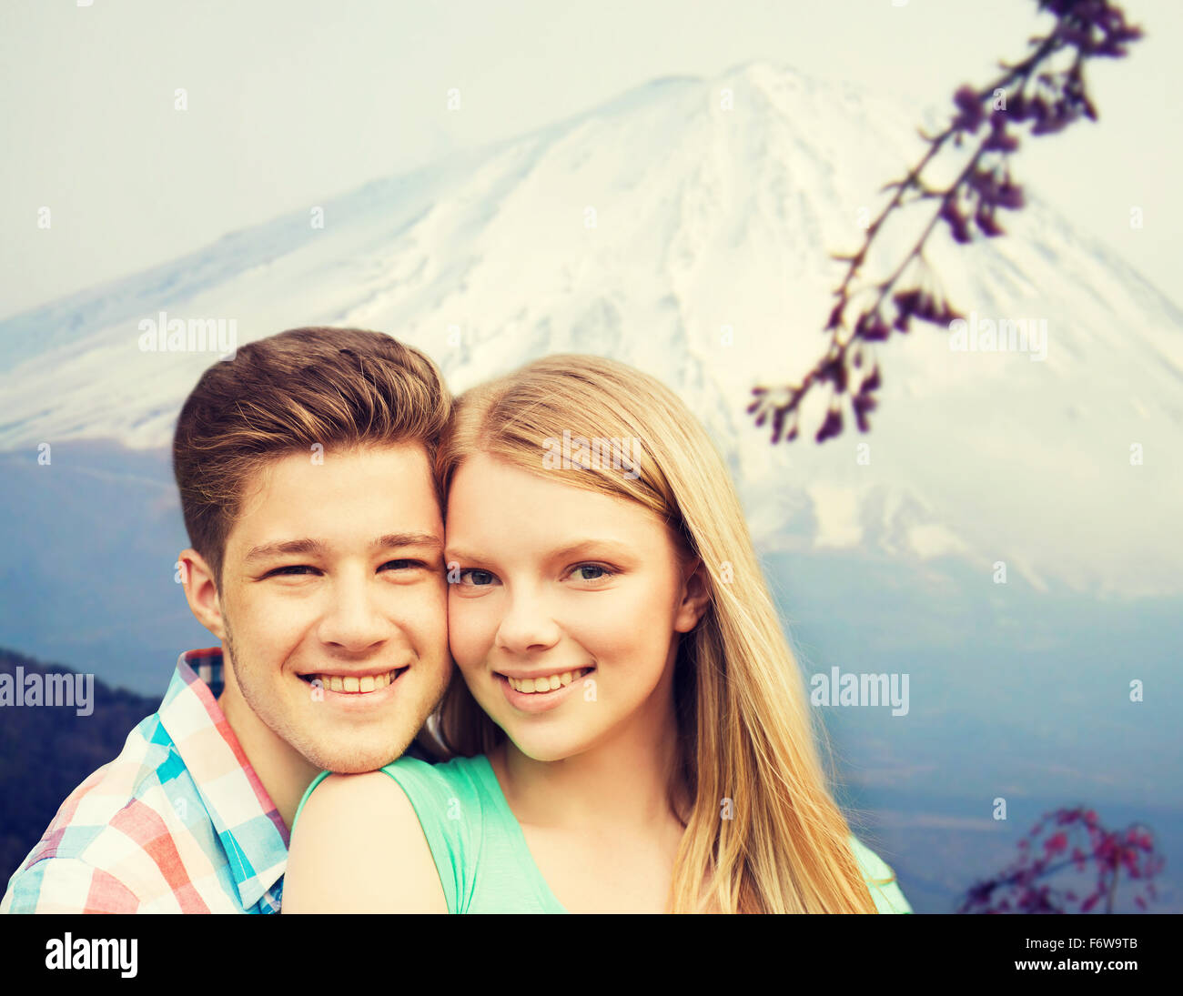 smiling couple hugging over mountains background Stock Photo - Alamy