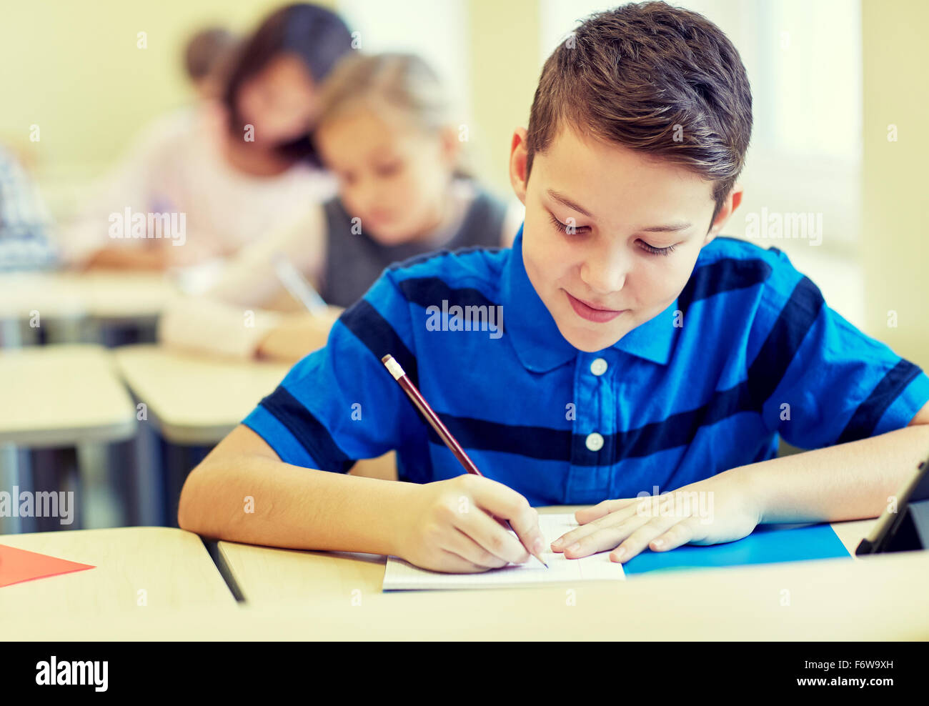 group of school kids writing test in classroom Stock Photo Alamy