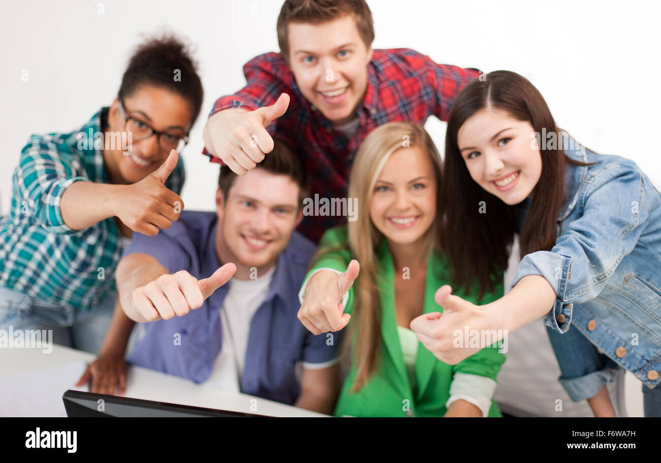 group of happy students showing thumbs up Stock Photo - Alamy
